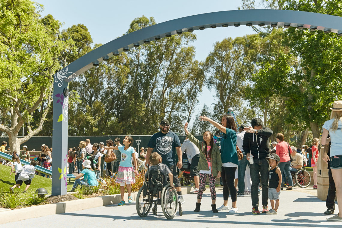 Children and adults interact with the Magical Harp by light artist Jen Lewin