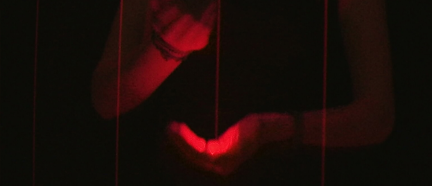 An attendee interacting with the Long Harp by Jen Lewin